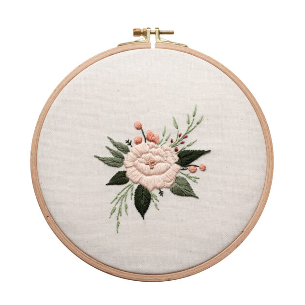 Cotton fabric embroidered with flowers in embroidery hoop